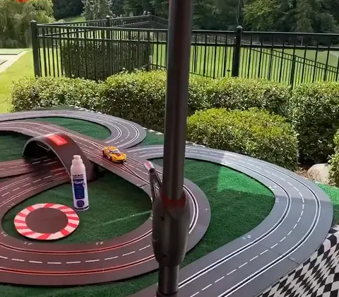 Slot car track set up outdoors on a patio