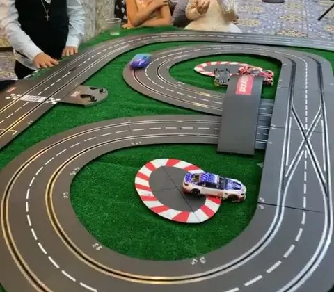 Slot car on a two-lane track with a red and white curb