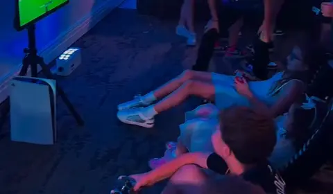 Guests gaming in a room lit blue and pink