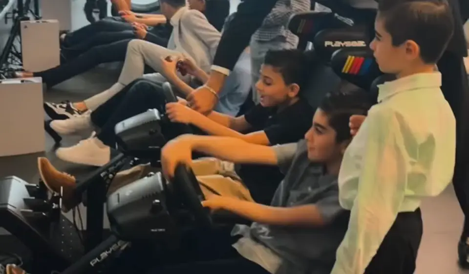 Guests racing in a row of simulator seats at an event
